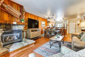 a living room with a fireplace and a table at Winter Park Condo w/ Resort Shuttle On-Site! in Winter Park