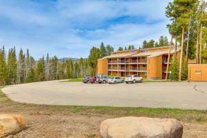 a large building with cars parked in a parking lot at Winter Park Condo w/ Resort Shuttle On-Site! in Winter Park
