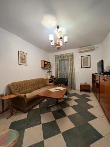 a living room with a couch and a table at Renome in Petrovac na Moru