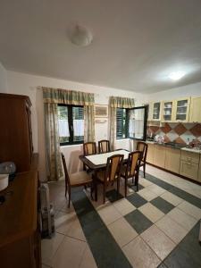 a kitchen with a dining room table and chairs at Renome in Petrovac na Moru
