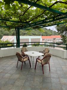 a table and two chairs and a white table and chairs at Renome in Petrovac na Moru