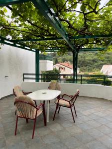 a table and two chairs on a patio with a view at Renome in Petrovac na Moru