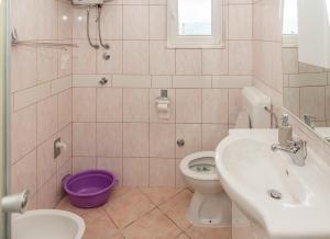 a bathroom with a toilet and a sink at Apartmani Danijel in Nin +41 photos