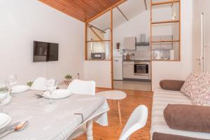 a living room with a white table and a couch at Apartmani Danijel in Nin