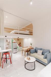 a living room with a blue couch and a table at Shanghai Hills& XING 479 B&B in Shanghai