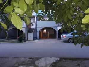 a car parked in front of a house at Apartman Božur in Trebinje