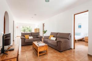 a living room with two couches and a tv at Villa Binisaret I by Mauter Villas in Cala Blanca
