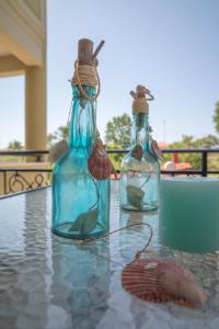 two bottles with fish in them sitting on a table at Homelia in Limenaria