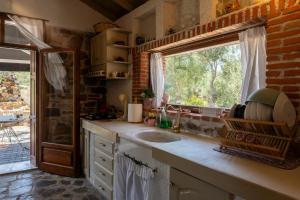 a kitchen with a sink and a window at Seaview Two Bedroom Villa in Yera Bay, Lesvos in Perama +57 photos