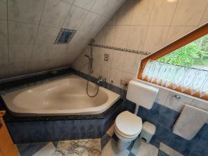 a bathroom with a tub and a toilet and a sink at Room Janez in Preddvor +2 photos
