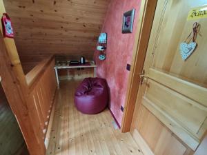 an attic room with a purple bean bag chair next to a door at Room Janez in Preddvor