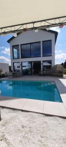 a house with a swimming pool in front of a house at Exklusiv Ferienwohnung Nähe Europas größtem Baumkronenweg in Diersbach