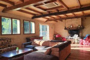 a living room with a couch and a table at Gîtes et Camping Hameau Nouste Temps in Castelnau-Magnoac