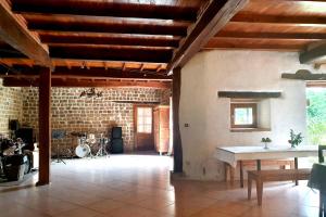 a living room with a table and a brick wall at Gîtes et Camping Hameau Nouste Temps in Castelnau-Magnoac +43 photos