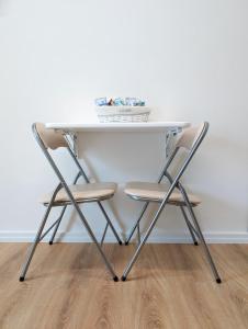 a white table with two chairs under it at B&B Civico 66 in Diamante