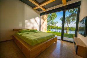 a bedroom with a bed with a large window at Lux Vila Mag 2002 in Lipnički Šor +39 photos