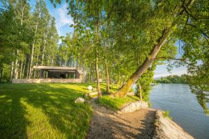 a house on the shore of a body of water at Lux Vila Mag 2002 in Lipnički Šor