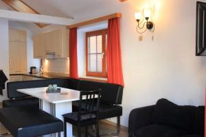 a living room with a table and chairs and a kitchen at Chalet Mariapfarr in Mariapfarr