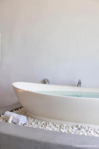 a white bath tub sitting on a counter in a bathroom at Hacienda Na Xamena, Ibiza in Na Xamena