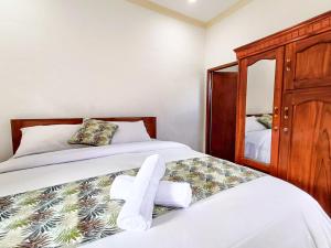 Postel nebo postele na pokoji v ubytování Wisuda Guest House
