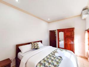 Postel nebo postele na pokoji v ubytování Wisuda Guest House