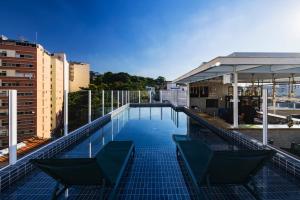 a swimming pool on the roof of a building at Arosa Rio Hotel in Rio de Janeiro