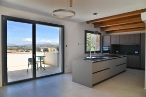 a kitchen with a sink and a table with a view at Tenuta Rapillo in Castellammare del Golfo