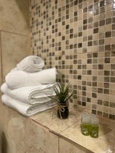 a pile of towels on a counter in a bathroom at Ada's Luxury Apartment - Old City in Braşov +43 photos