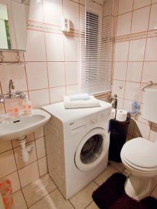 a bathroom with a washing machine and a toilet at Center Magnifique apartment, OLD TOWN in Split