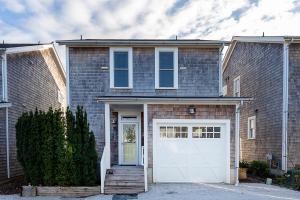 a brick house with a white garage at Bigfoot by Seabrook Hospitality in Pacific Beach