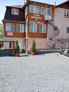 a building with a sign that reads casa heinemann mill at Casa Hermina in Sovata