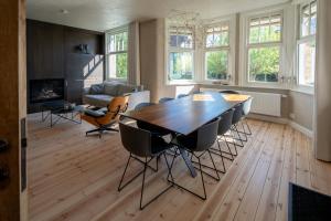 a living room with a wooden table and chairs at Villa-Sabbia in Koksijde