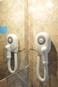 a bathroom with a phone on the wall at Bosque Encantado Cabañas in Villa Icho Cruz
