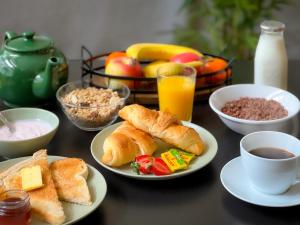 a table with plates of breakfast foods and a cup of coffee at Timbertop Suites - Adults Only in Weston-super-Mare
