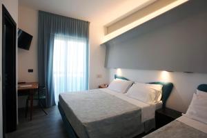 A bed or beds in a room at Hotel Ali d'Oro