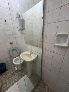 a bathroom with a toilet and a sink at Hotel GMatos Belo Horizonte - By UP Hotel in Belo Horizonte