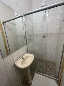 uma casa de banho com um chuveiro, um WC e um lavatório. em Hotel GMatos Belo Horizonte - By UP Hotel em Belo Horizonte