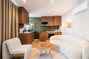 a living room with a white couch and a table at Beachside House in Matosinhos by Lisbeyond in Matosinhos