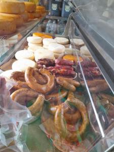 a display case with different types of pretzels and sausage at O Cantinho da Auzenda in Torre de Moncorvo +6 photos