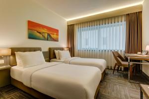Ένα ή περισσότερα κρεβάτια σε δωμάτιο στο Plus Hotel Bostanci Atasehir