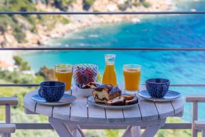 einen Tisch mit einem Tablett mit Frühstückszutaten und Getränken in der Unterkunft Sea View Studios in Skopelos