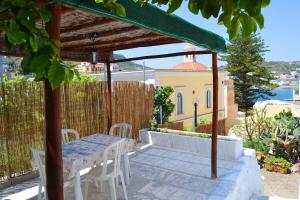 a table and chairs under an umbrella on a patio at Maridea - Marlin in Ponza