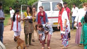 a group of people standing in front of a van at Clayfingers Art Cottage in Trichūr