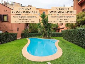 a swimming pool in a yard with a palm tree at The Best Rent - Elegant apartment in Trastevere in Rome