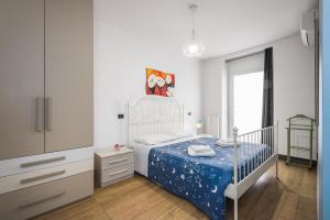 a small bedroom with a bed and a dresser at Appartamento Happy in Verona