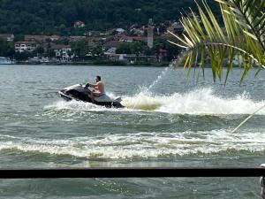 a man on a jet ski in the water at CHALET Orsova in Orşova