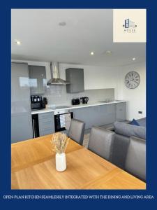 a kitchen and living room with a table and a couch at Flat 507 Modern Luxury Living in Yeadon