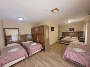 a room with three beds in a room at Bülent Kocabaş-Selinus Beach Club Hotel in Gazipasa