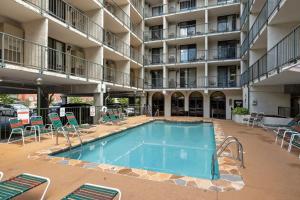 a swimming pool in the middle of a building with chairs at Beary Convenient is a Newly Renovated King Suite Condo in the heart of Gatlinburg with pools in Gatlinburg