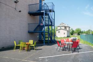 a group of tables and chairs next to a building at Diplomat Inn in Niagara Falls